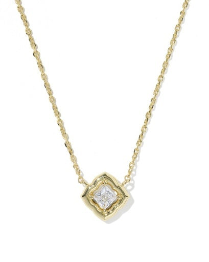 A delicate yellow gold chain necklace featuring a small, geometric four-pointed pendant with a clear central gemstone, set against a plain white background.