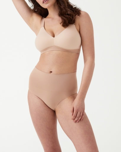 Model wearing a tan bralette that is lightly lined and has comfortable support