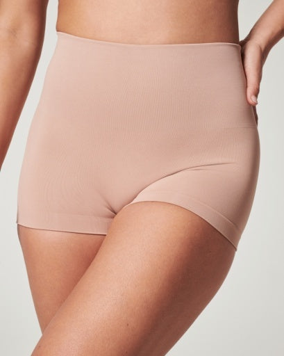 Model wearing Spanx Beige Boyshorts that include Tummy Control