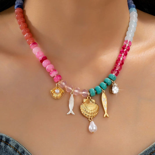 muilt-color beaded necklace with fish, seashell, and rhinestone charms. 
