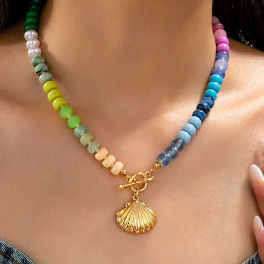 multi-color beaded necklace with a seashell charm.