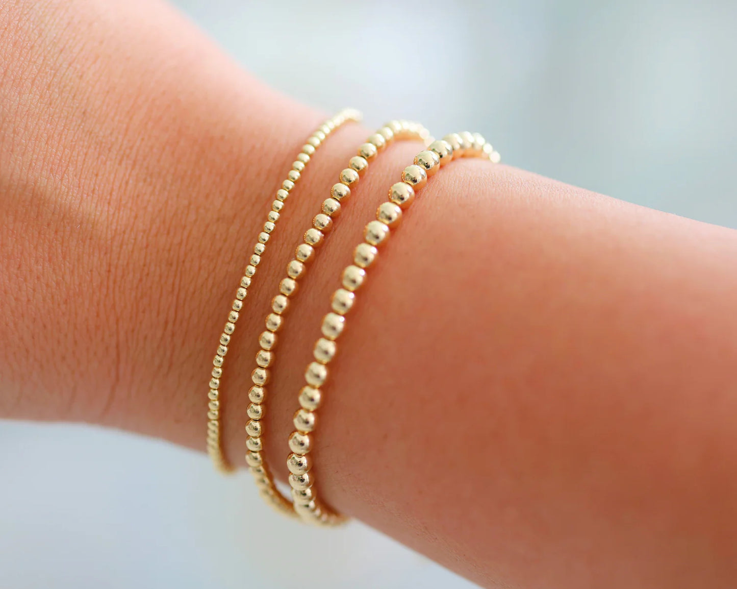 set of 3 gold beaded bracelets BEAD MATERIAL:&nbsp;GOLD FILLED STRETCHY LENGTH:&nbsp;6.5" OR 7" HIGH PERFORMANCE ELASTIC