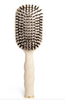 Oval hair brush, beige handle, boar bristle, textured handle with gold trim