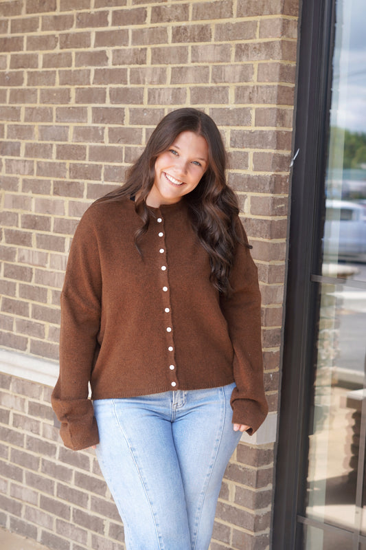 Women wearing a brown button down sweater, round neckline, long sleeve, relaxed fit