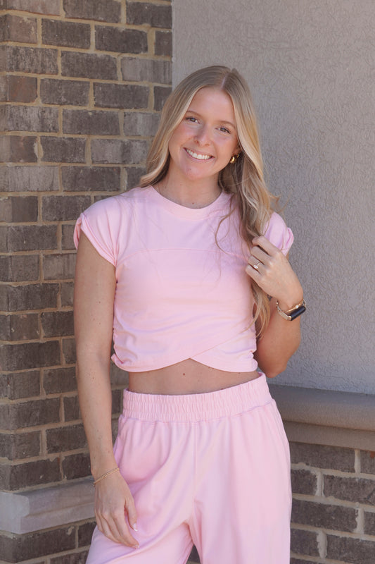 Women wearing a Pink Crossover Top, Round Neckline, Cap Sleeves, slightly Cropped.