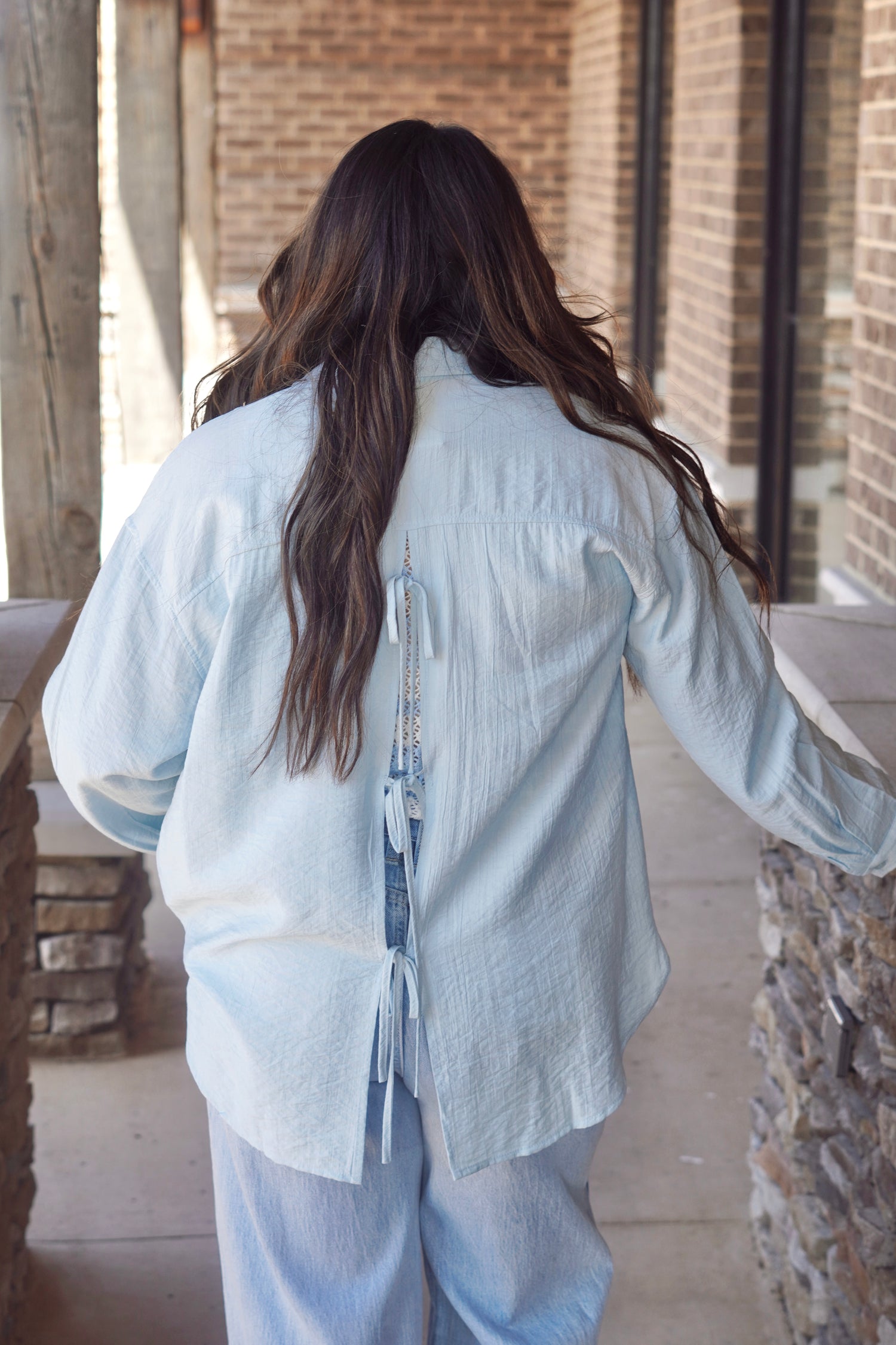 Blue button up with ties details in the back.