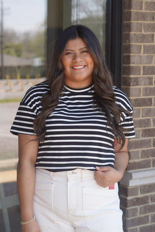 Women wearing a black and white stripes top, short sleeve with a round neckline