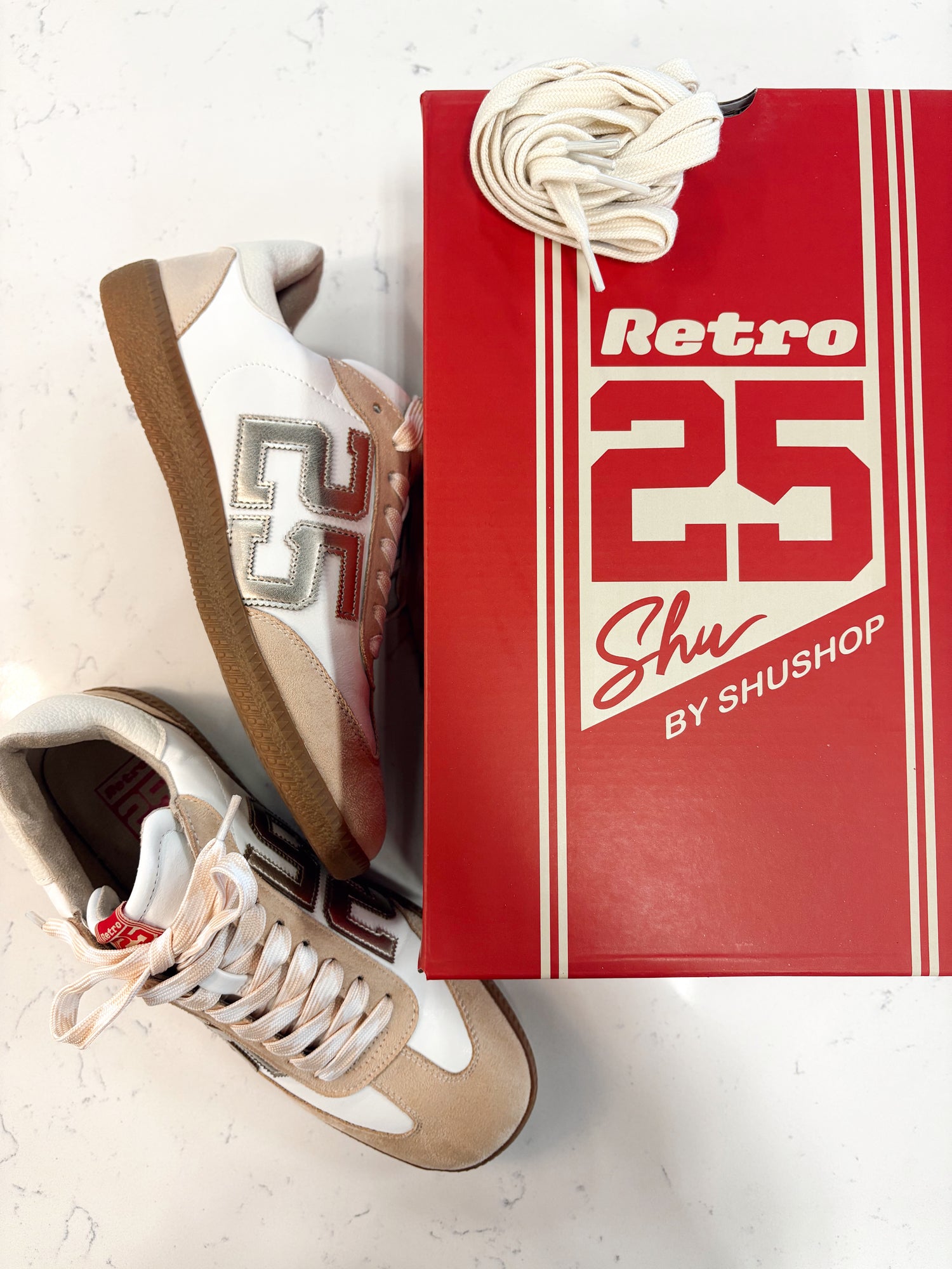 Tan and White Sneakers tith Retro 25 Detail on the side, Small Gold Accents, red shoe box