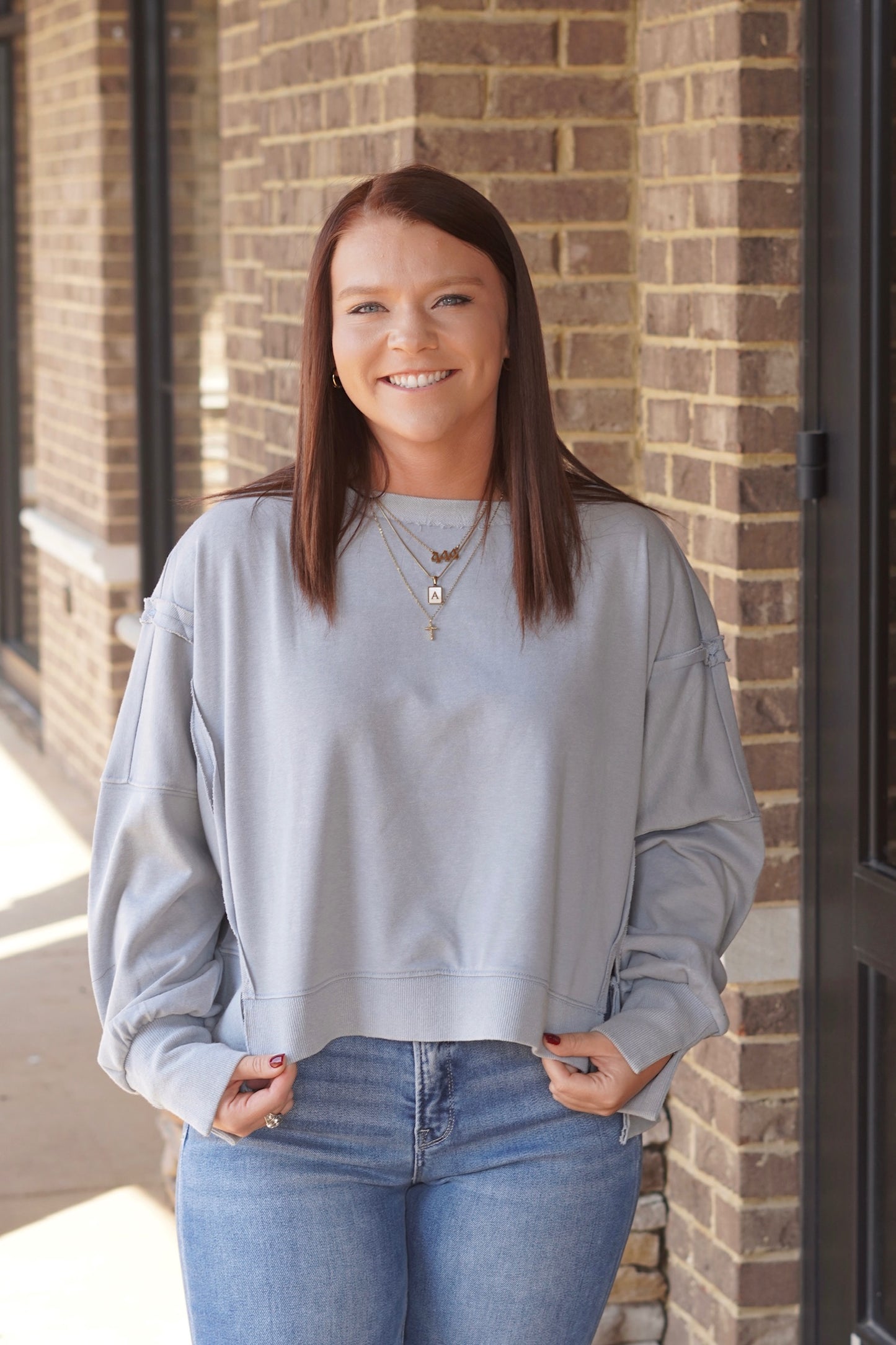 Women wearing Cropped Sweatshirt in a ash grey color, Round Neckline, Long Sleeves.