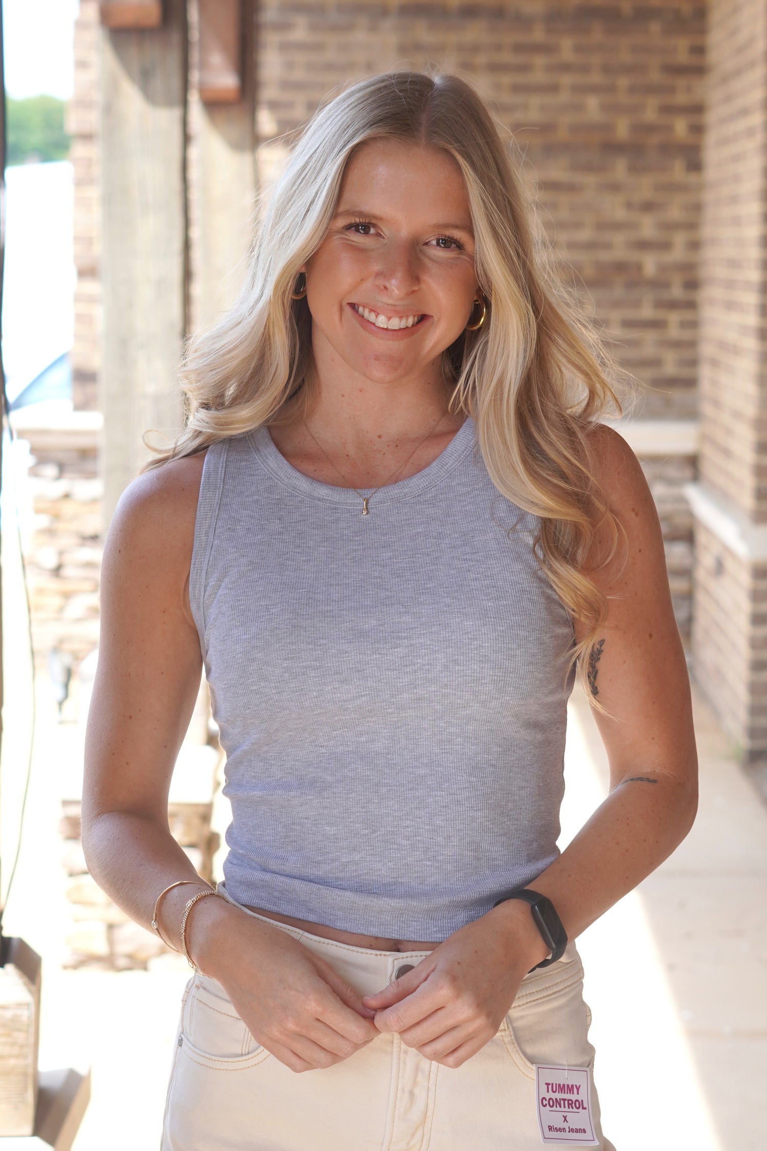 Women Wearing a Grey Ribbed Tank, Sleeveless, Round Neckline. 