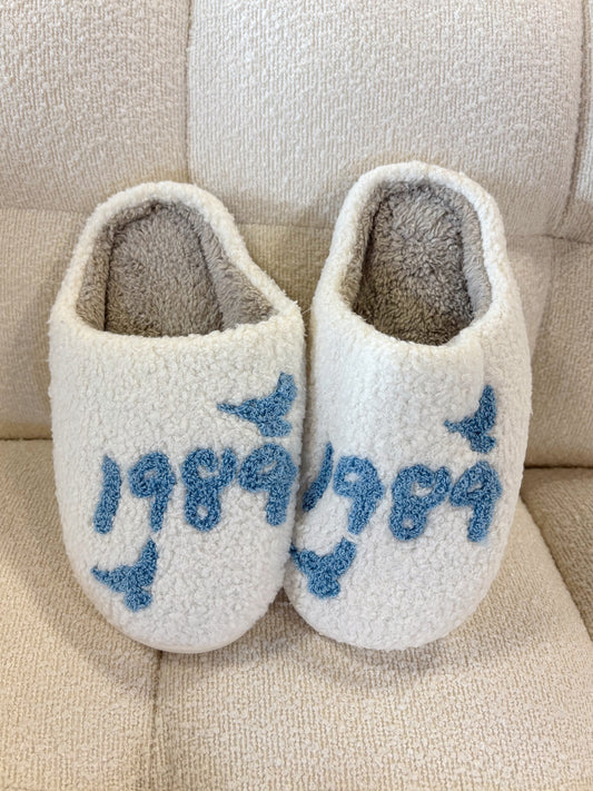 White House slippers with "1989" and birds written in blue 