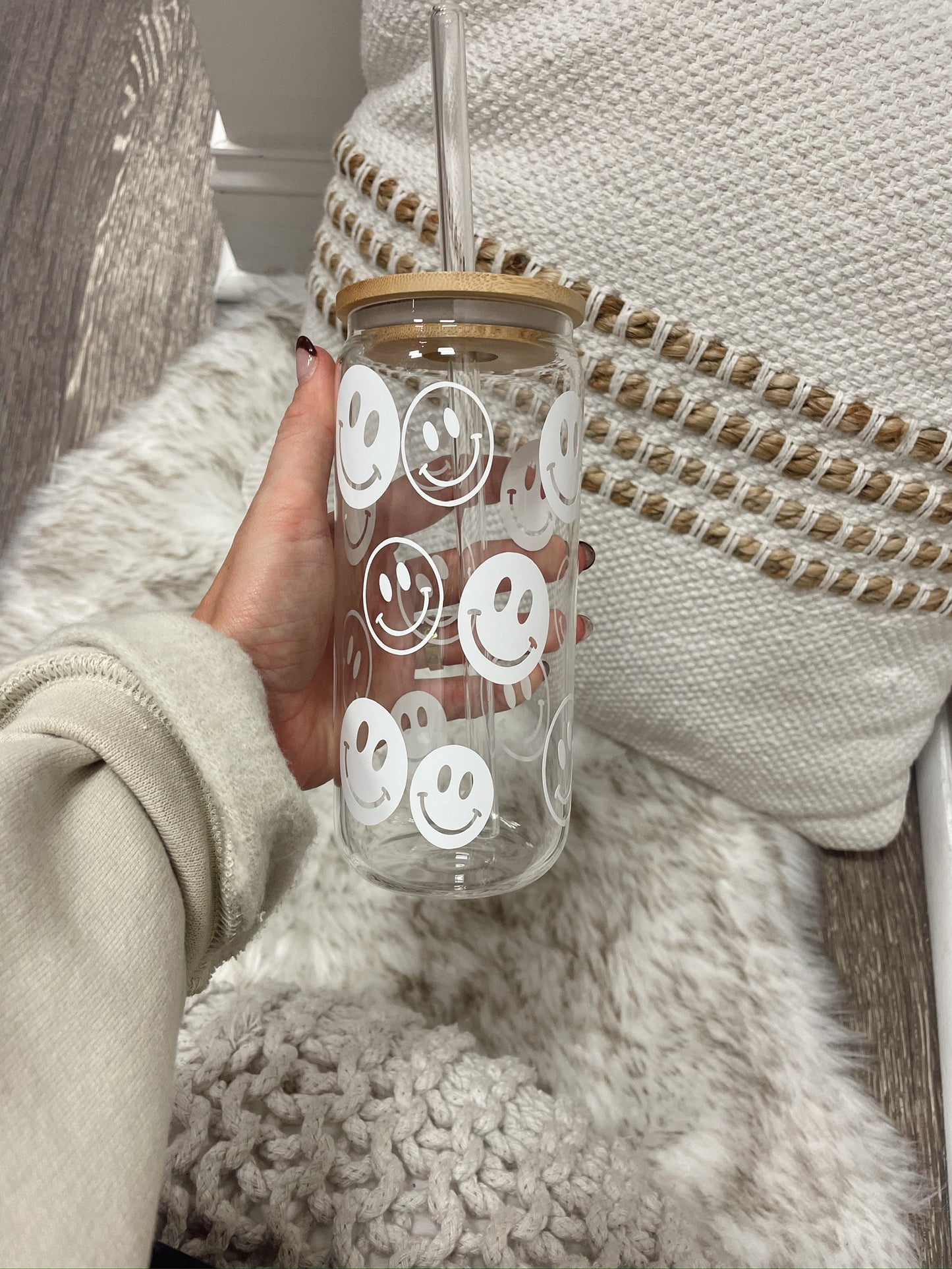 clear glass cup with straw with white smiley face design