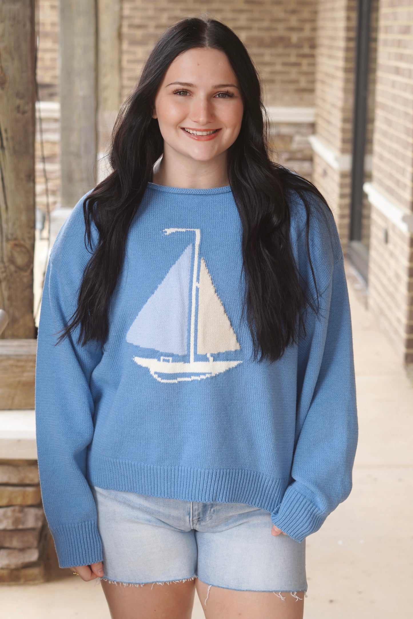 Women wearing a Blue Sweater, with a Baby Blue and Cream Sail boat, Boat neckline 
