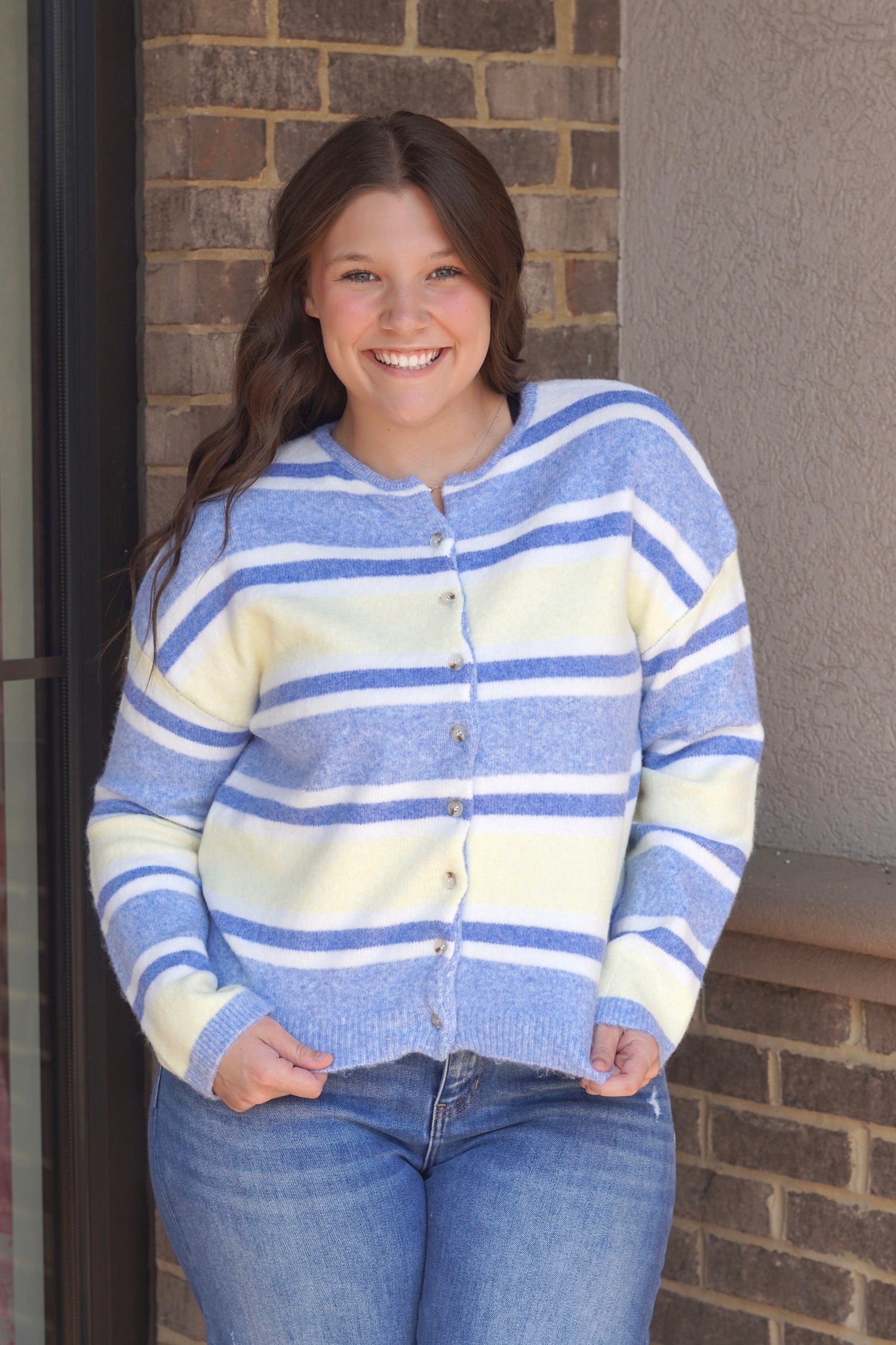 A blue and yellow button up cardigan sweater. 
