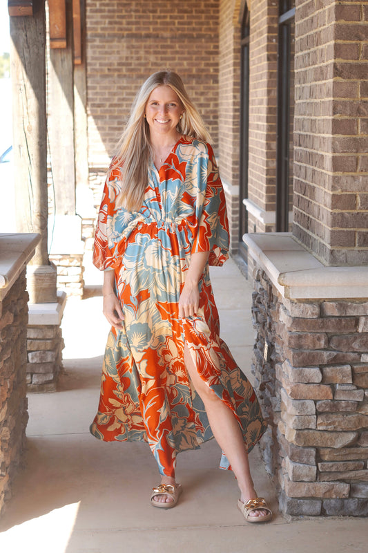 Women wearing a printed maxi Dres, v neckline, flowy, slit, half-arm sleeves.