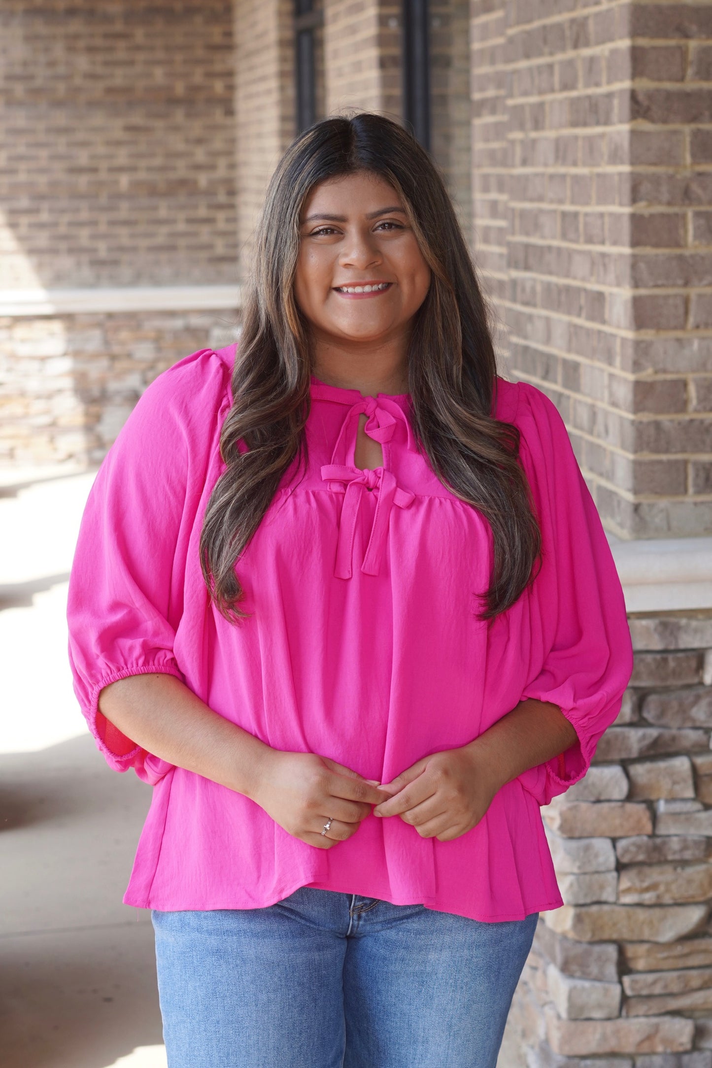 Women wearing a Pink Bows Blouse, Round Neckline, Batwing Sleeve, Relaxed Fit, Full Length. 