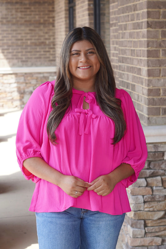 Women wearing a Pink Bows Blouse, Round Neckline, Batwing Sleeve, Relaxed Fit, Full Length. 