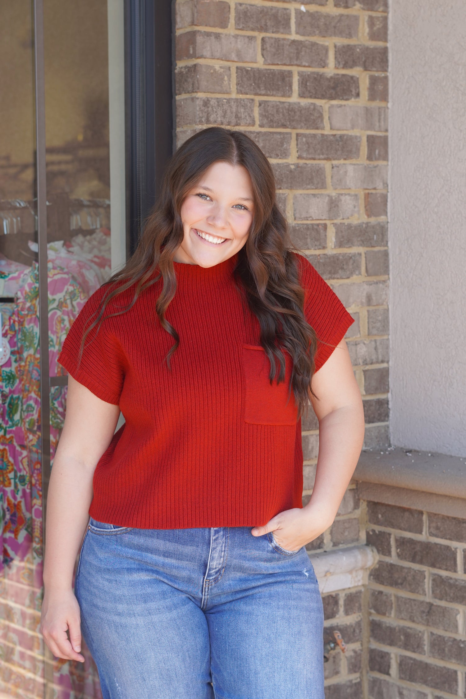 A short-sleeve ribbed knit mock neck top in a vibrant red color