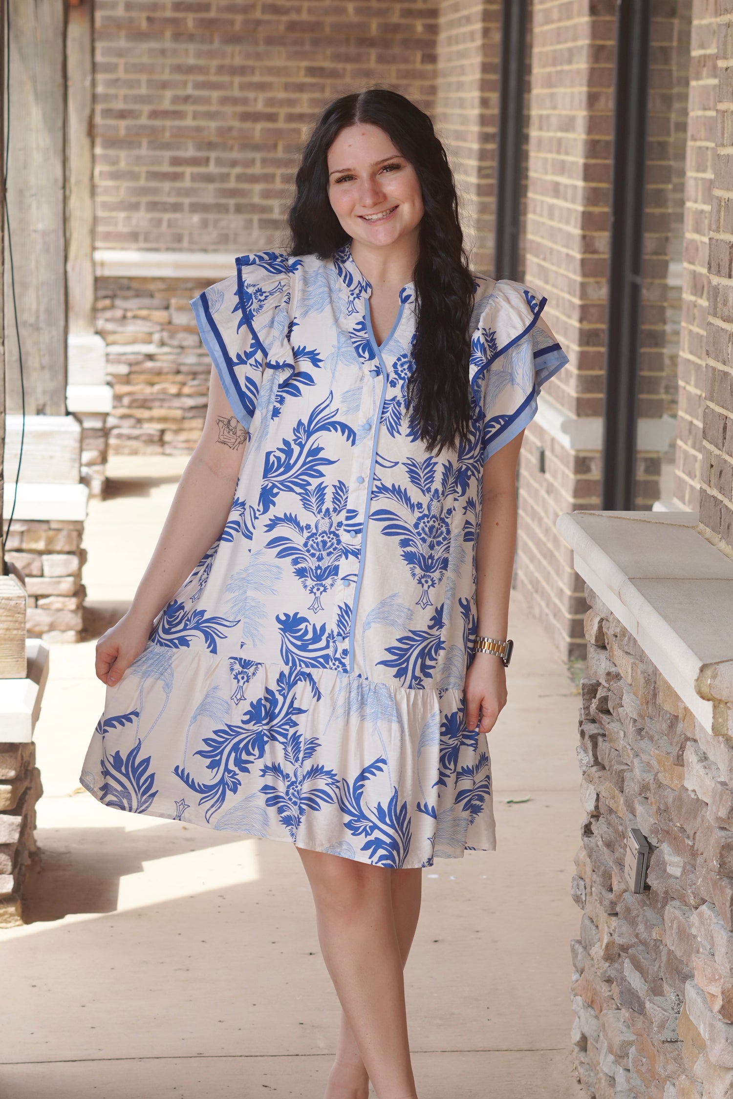 Women Wearing a Blue Floral Dress, V-Neckline, Ruffle Sleeves, Mid Thigh Length, Button Down