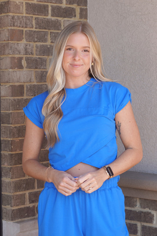 Women wearing a royal blue Crossover Top, Round Neckline, Cap Sleeves, slightly Cropped.