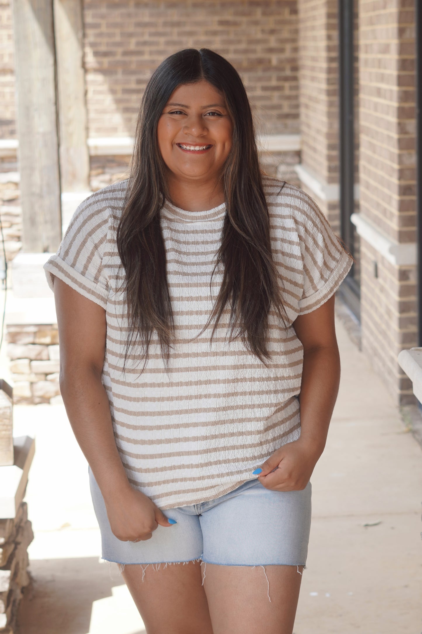 Women Wearing a Tan Striped Short Sleeve Top, with a Round Neckline, and texture knit material. 