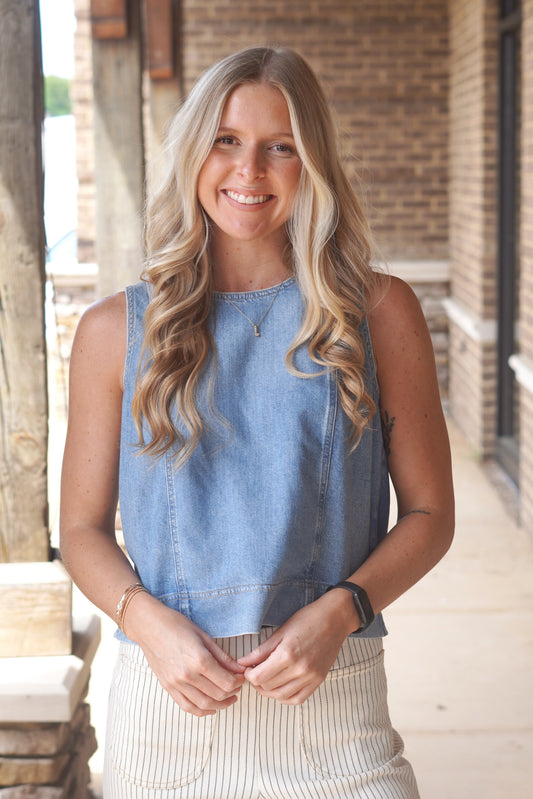 Women Wearing a Denim Top, Sleeveless, Round neckline, Flowy. 