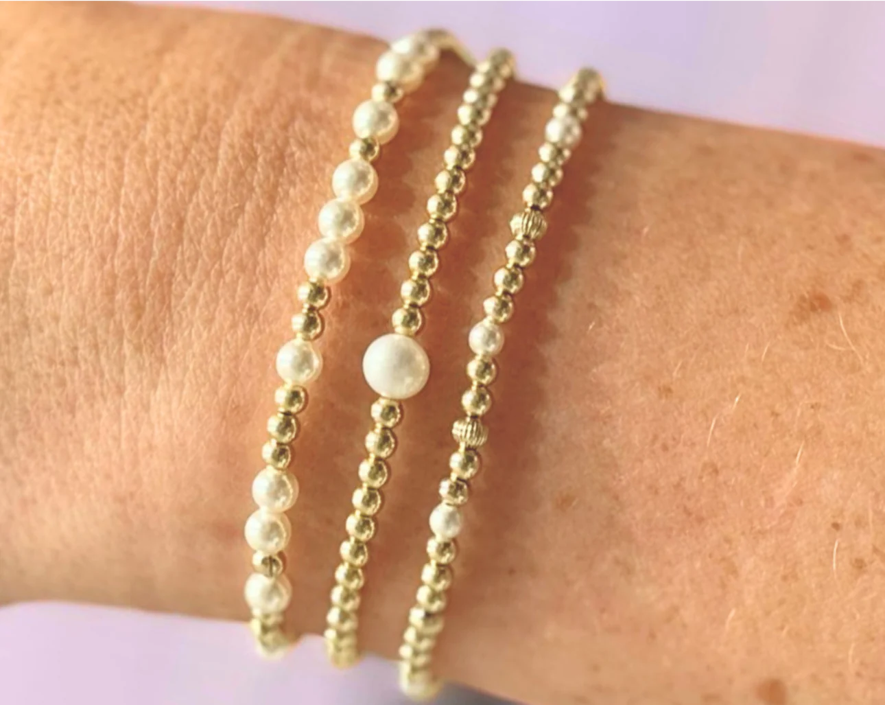 set of 3 gold and pearl beaded bracelets BEAD MATERIAL:&nbsp;GOLD FILLED, FRESHWATER PEARLS STRETCHY LENGTH:&nbsp;6.5" OR 7" CLASP LENGTH:&nbsp;6" + 1.5" EXTENSION HIGH PERFORMANCE ELASTIC