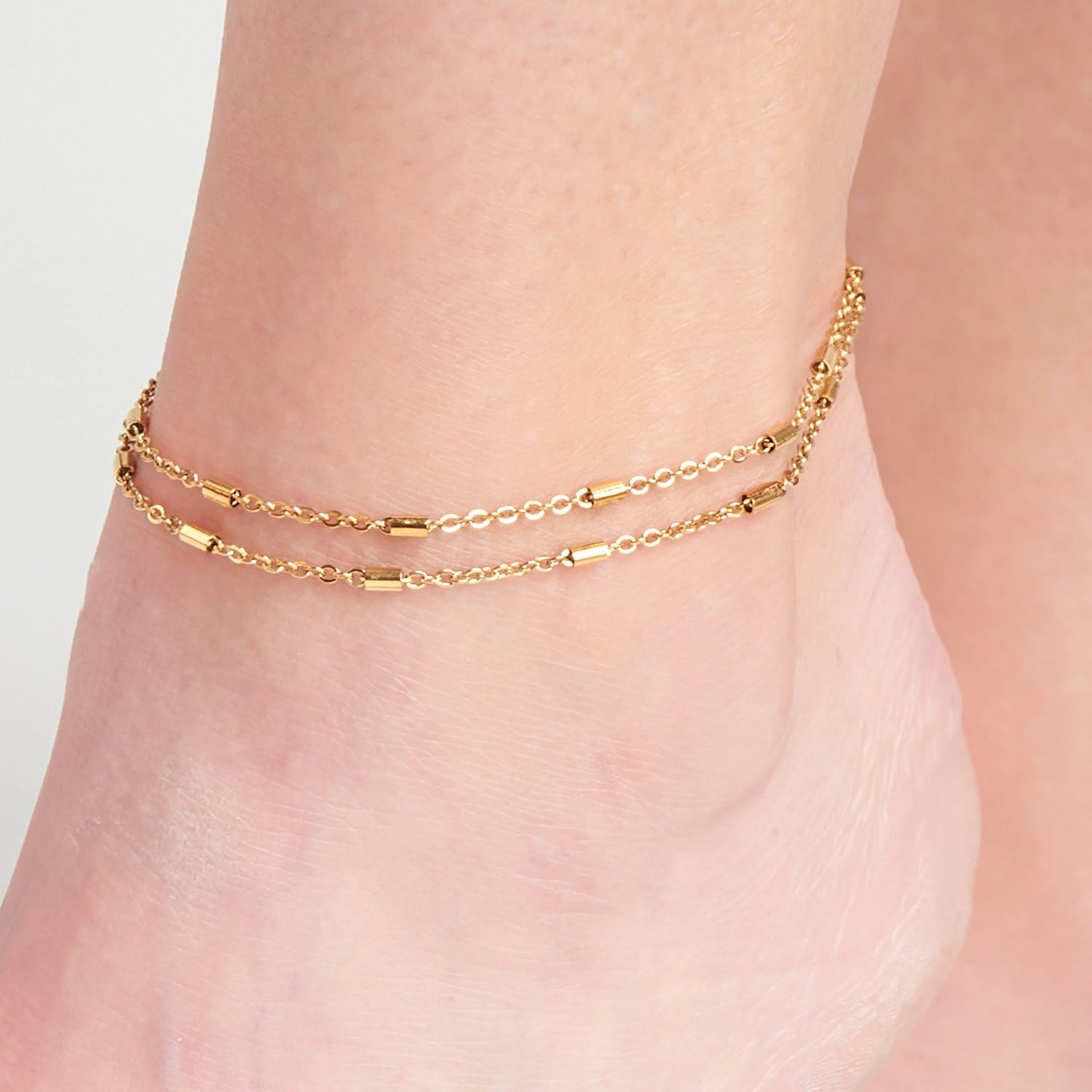 Dainty Bar Anklet offers two bands of sleek, dainty bar chains in a classic gold.