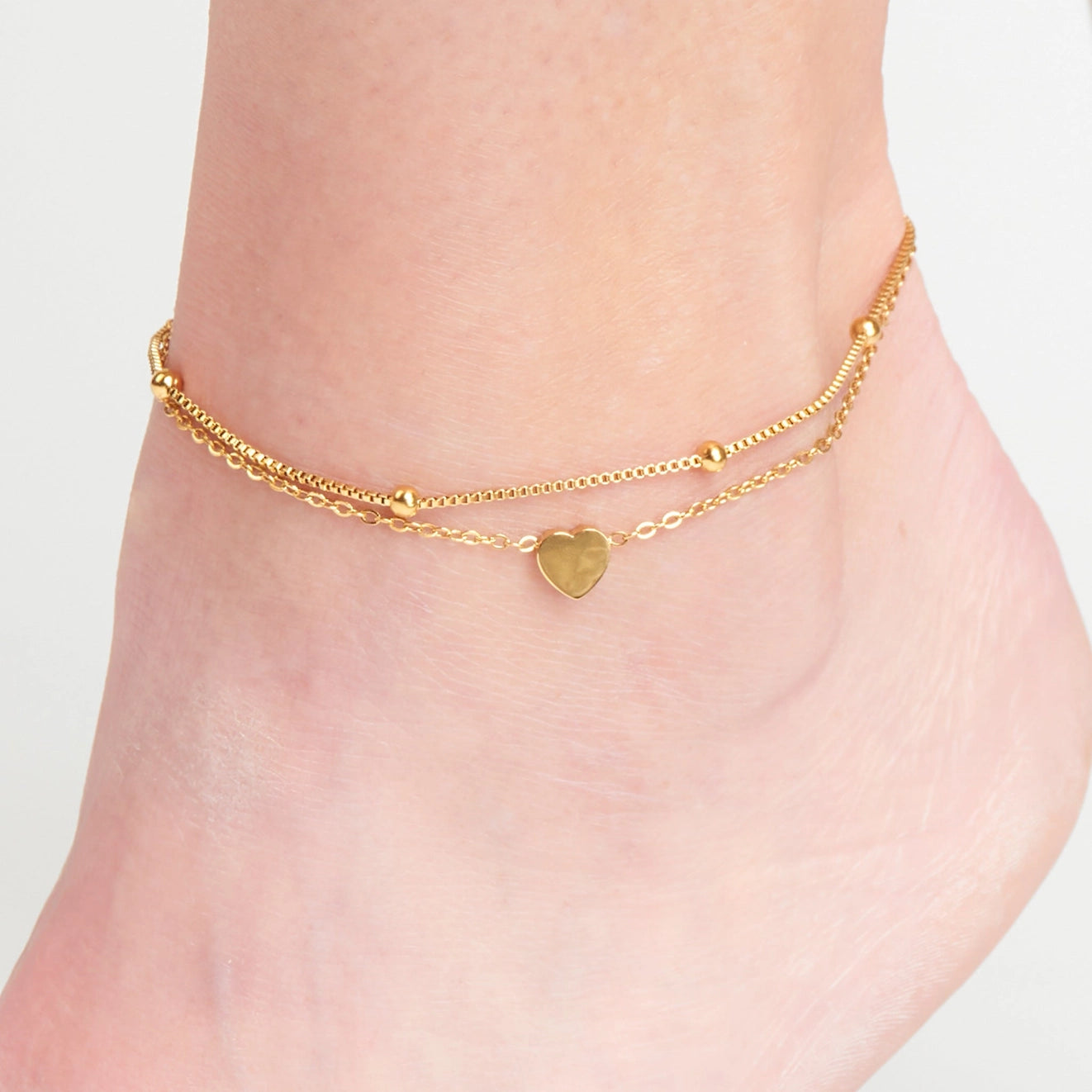  Multi Row Heart Anklet offers two chains in a chic gold with cute heart charm detailing
