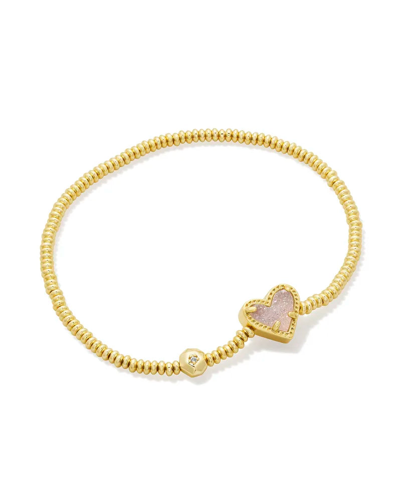 gold stretch bracelet with iridescent drusy stoned heart charm , and a larger bead charm