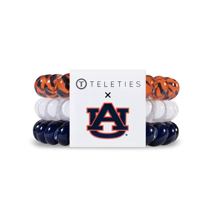 set of 3 teleties: one orange and blue tiger print, one white, and one blue