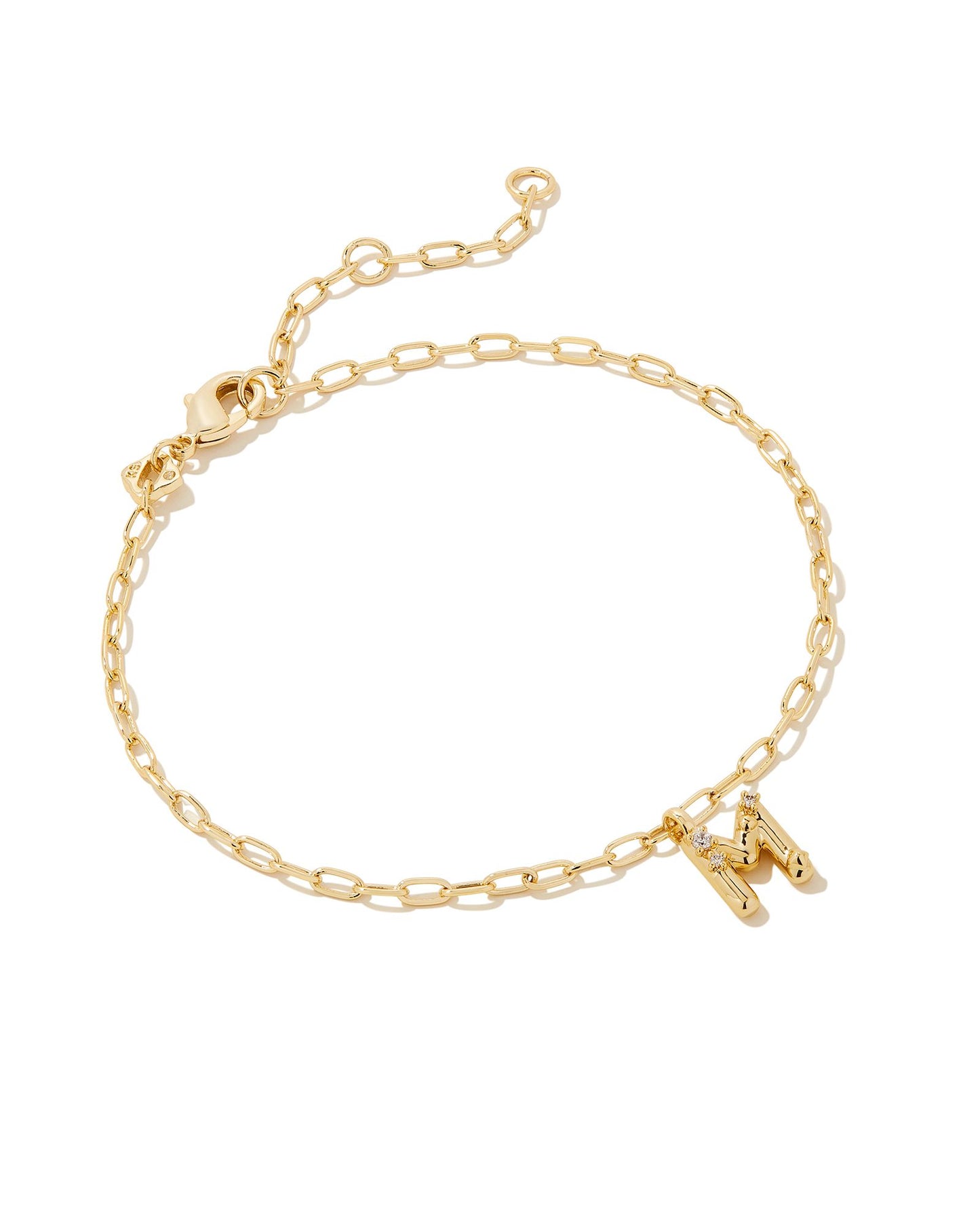 Add a personal touch to your wrist stack with the Crystal Delicate Chain Bracelet in White Crystal, our first Fashion Jewelry initial bracelet. Featuring a dainty chain and letter charm with a hint of sparkle, this bracelet is the perfect way to celebrate the ones you love—including yourself!  Dimensions- 6.5' CHAIN WITH 1.5' EXTENDER, 0.45'L X 0.26"W PENDANT Metal- 14K Gold plated over brass Closure- Lobster Clasp Material-  White CZ Letter M