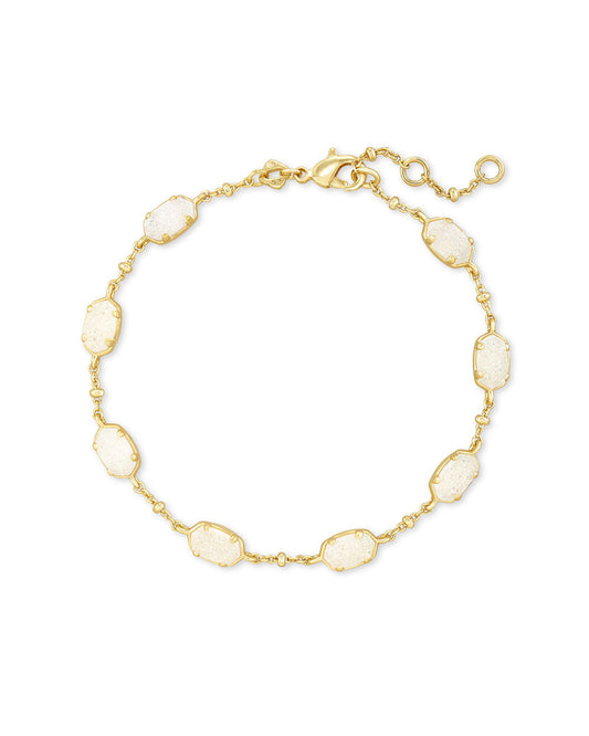 The Emilie Gold Link Bracelet is designed with mini, classic KS shapes linked by a shimmery metallic satellite Chain. Layer for a little extra something in your minimalist stack!  Dimensions- 6.5 L circumference, 0.25" X 0.20" stations Metal- 14k Yellow Gold Over Brass Closure- Lobster Clasp Material-  Iridescent Drusy