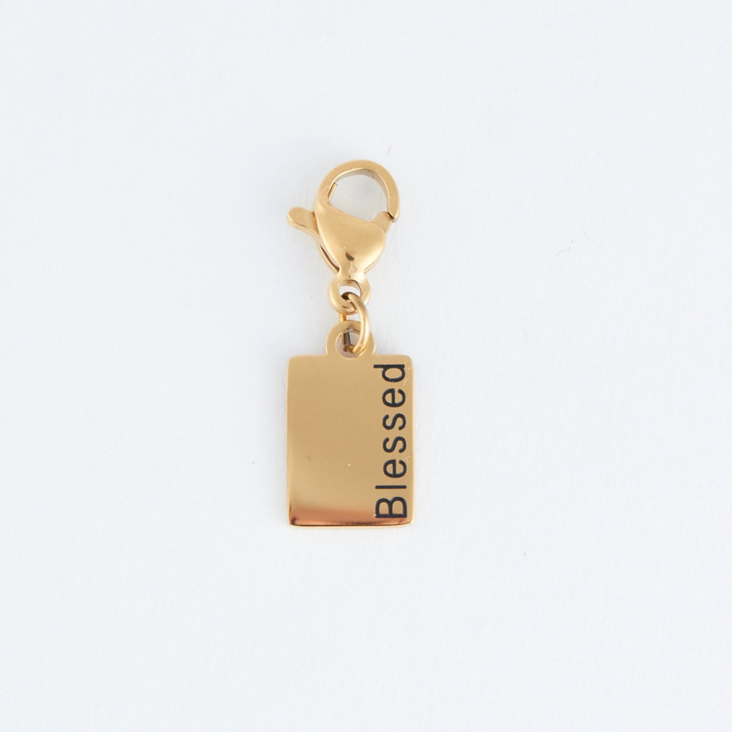 Gold rectangle charm with the word Blessed written, with a lobster clap. 