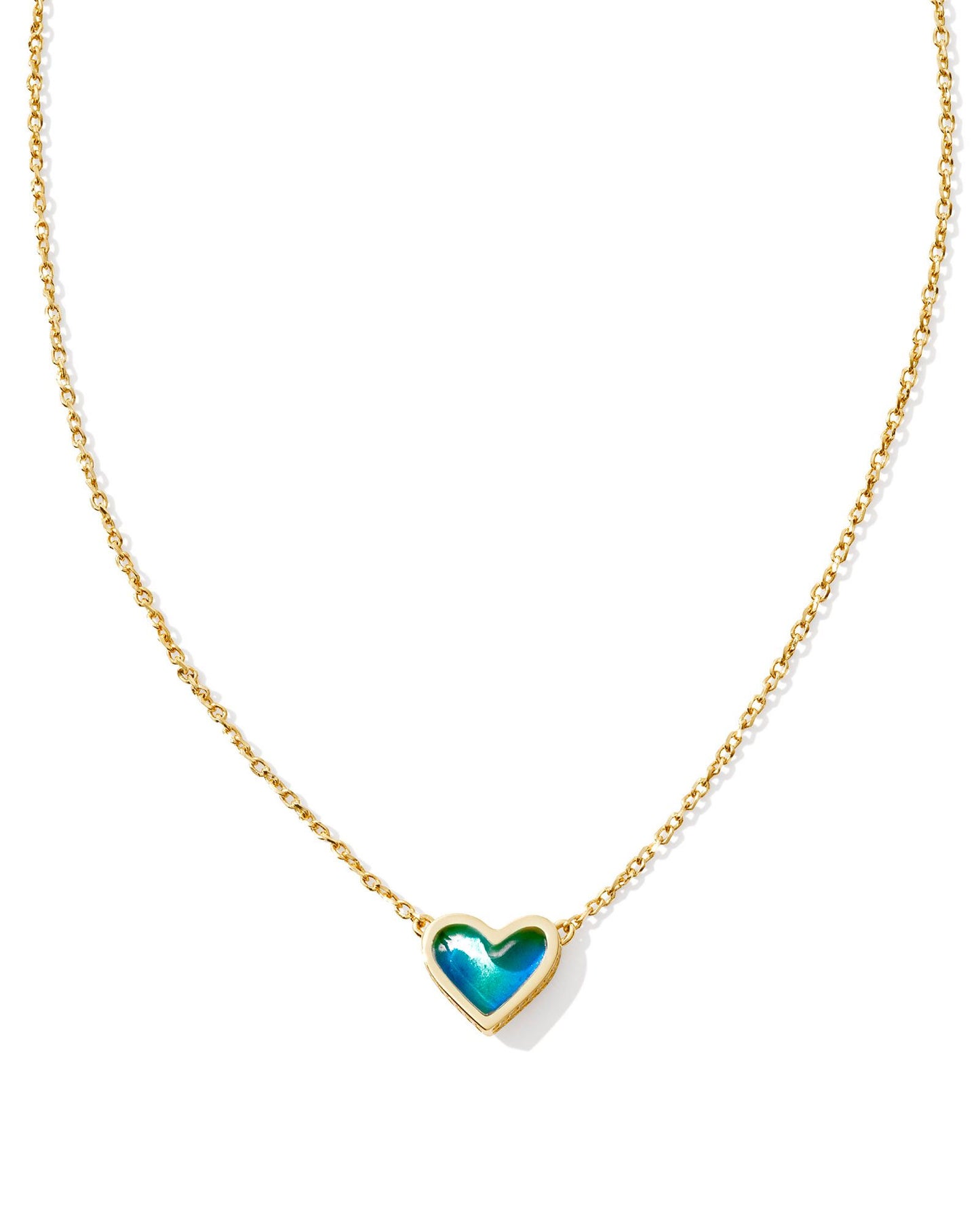 gold necklace with a heart pendant that has a blue moon stone stoned center