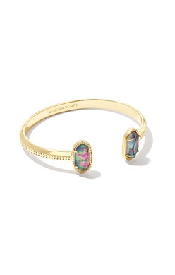 A dainty pinch cuff bookended with our signature oval stones, the Elton Gold Cuff Bracelet in Lilac Abalone is a stack staple. This beautifully designed gold cuff bracelet is guaranteed to turn heads every time you wear it. No matter the size of your wrist, our Elton Cuff Bracelet is sure to fit you and your style. Dimensions: 2.28' INNER DIAMETER, 0.37'L X 0.38"W STATIONS GOLD LILAC
