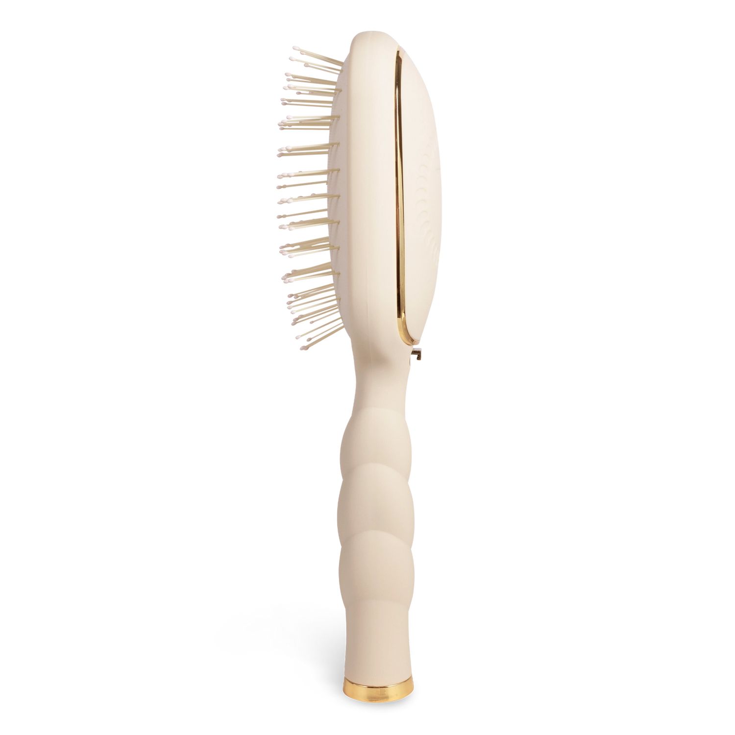 Oval hair brush, beige handle, gentle glide bristle, textured handle with gold trim shown from the side. 