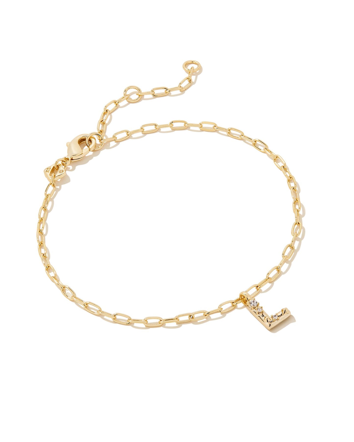 Add a personal touch to your wrist stack with the Crystal Delicate Chain Bracelet in White Crystal, our first Fashion Jewelry initial bracelet. Featuring a dainty chain and letter charm with a hint of sparkle, this bracelet is the perfect way to celebrate the ones you love—including yourself!  Dimensions- 6.5' CHAIN WITH 1.5' EXTENDER, 0.45'L X 0.26"W PENDANT Metal- 14K Gold plated over brass Closure- Lobster Clasp Material-  White CZ Letter L