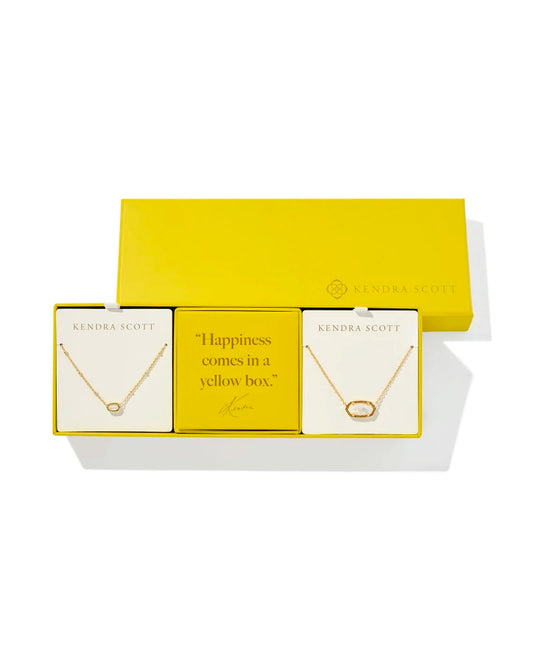 yellow gift box of two. gold necklace with small gold ivory pendant necklace, and another gold necklace with larger gold ivory pendant