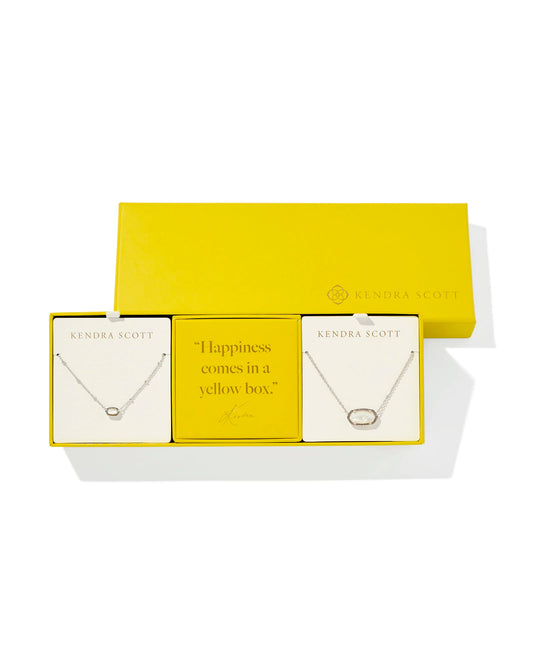 yellow gift set of two necklaces. silver necklace with a small ivory pendant, another silver necklace with a larger ivory pendant