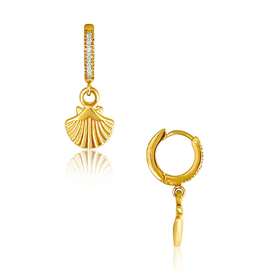 Gold earrings with a seashell charm hanging from a hoop with rhinestone detailing.