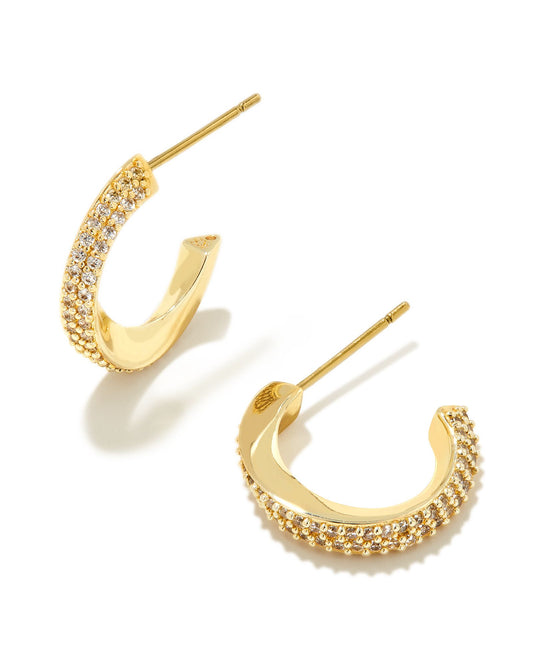 Adorable and on-trend, you’ll obsess over the Ella Gold Huggie Earrings in White Crystal. With a unique twisted metal shape, these huggies are studded with micro pavé crystals for a dimensional sparkle that can’t be ignored. Pair with an elegant chain to top off a chic, everyday look.