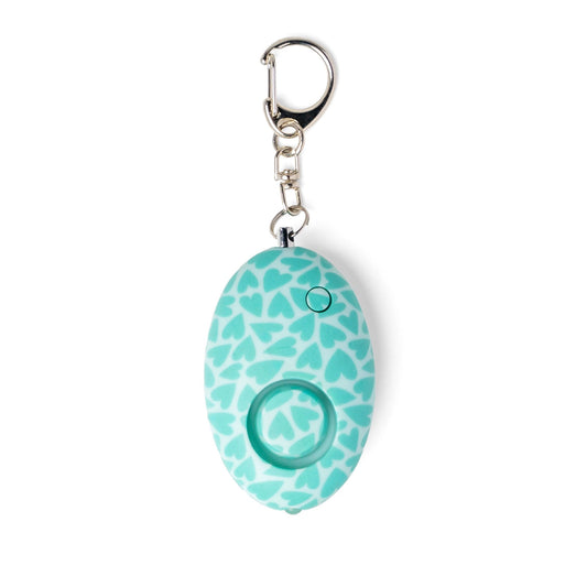 Teal background with darker teal hearts mini keychain alarm on display.