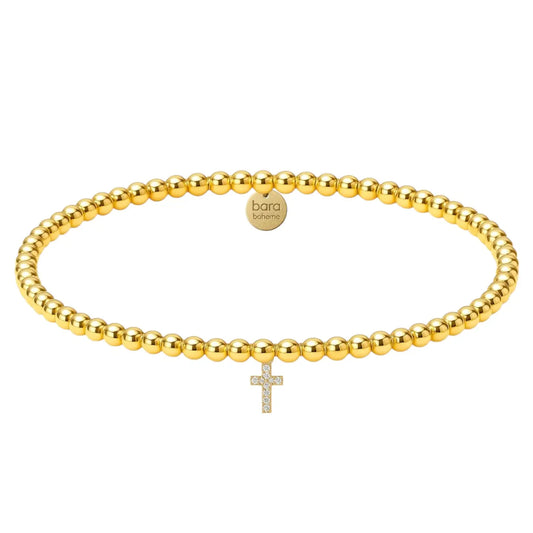 gold beaded bracelet with cross charm