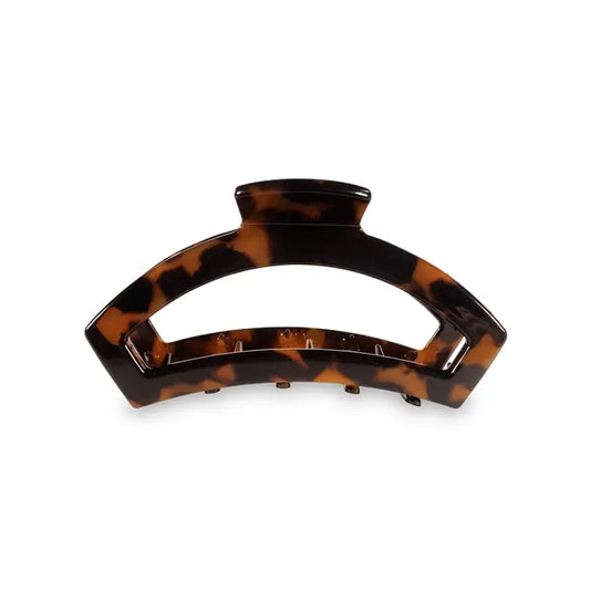 Our open hair clip offers the same incredible advantages as our classic claw clip, but with a unique open-style design that allows your hair to show through. Say goodbye to breakable clips! We have perfected the hair tie and now have re-invented the hair clip. Each clip has bendable teeth that take back to shape, they work on all hair types and have a strong hold. Hold your hair and enhance your style with the new TELETIES clip!  Tortoise color