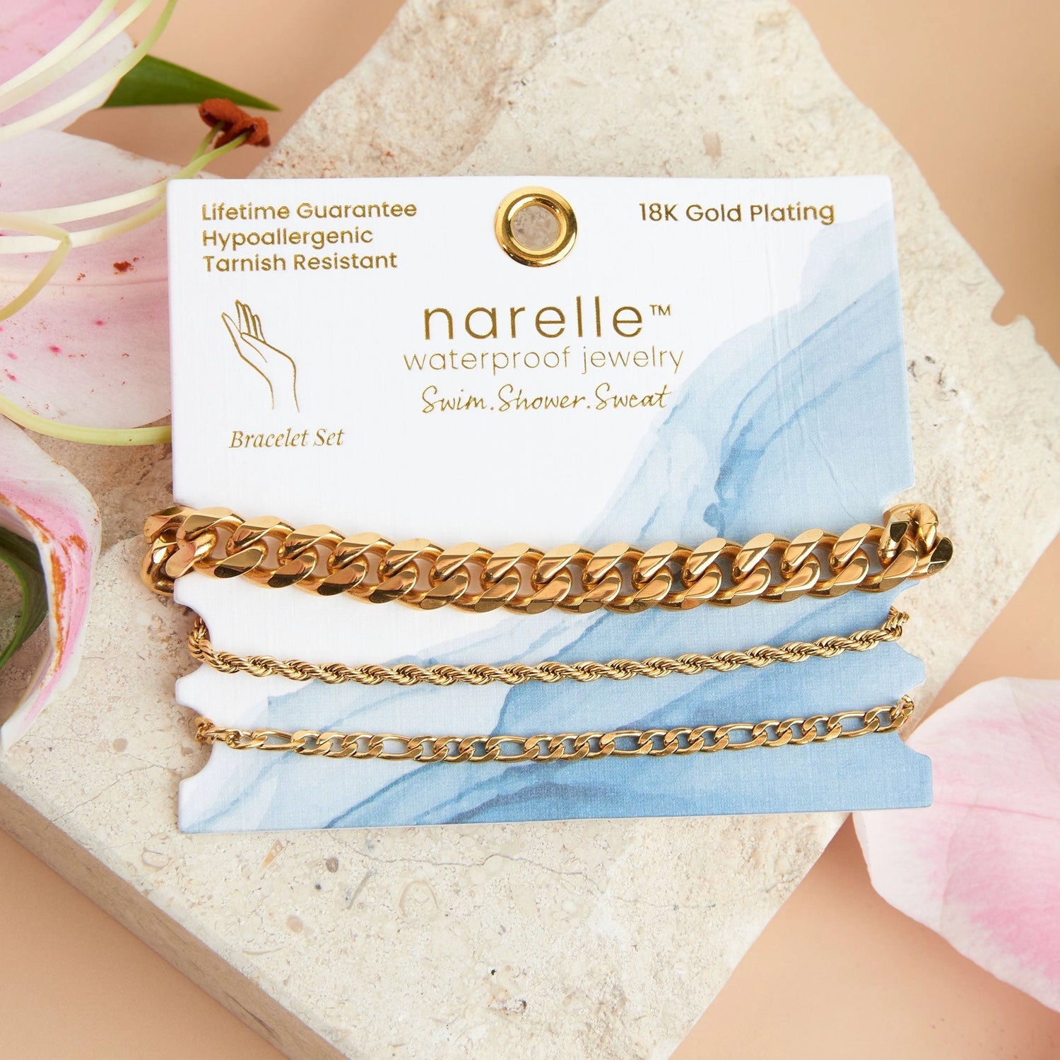 three pairs of gold bracelets in Chunky, Figaro, and Dainty Chain designs