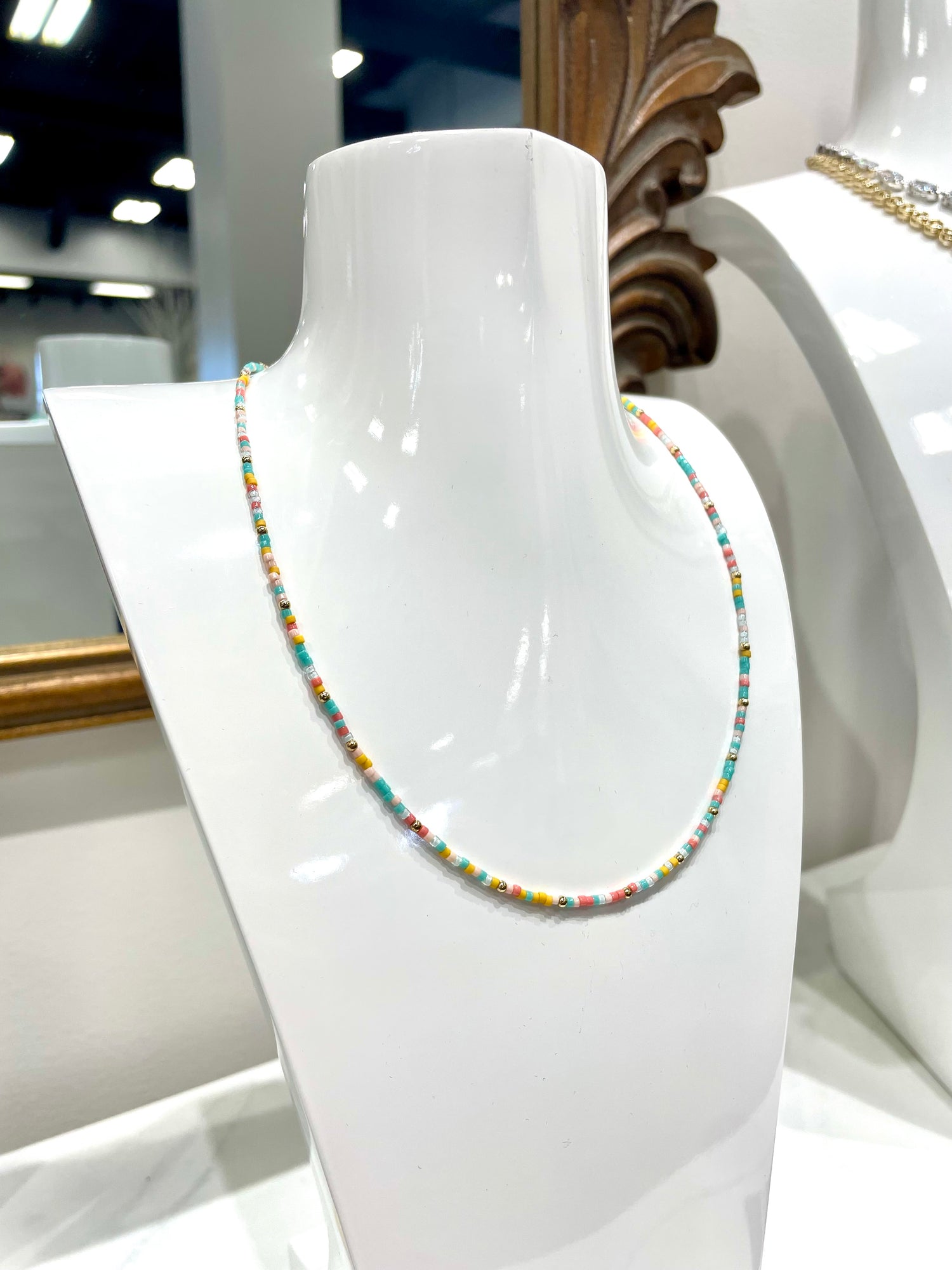 multicolored beaded necklace with vibrant color and gold beads. 