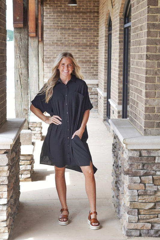 Carrie Collared Button Down Dress Collared Neckline Short Sleeves Button Down Style Color: Black Knee Length Pockets Relaxed Fit Front Pocket 100% Polyester