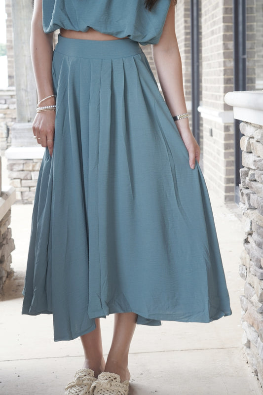 Totally Teal Box Pleated Midi Skirt High-Waisted Midi Length Color: Teal Subtle Pleated Flow Fit 100% Polyester