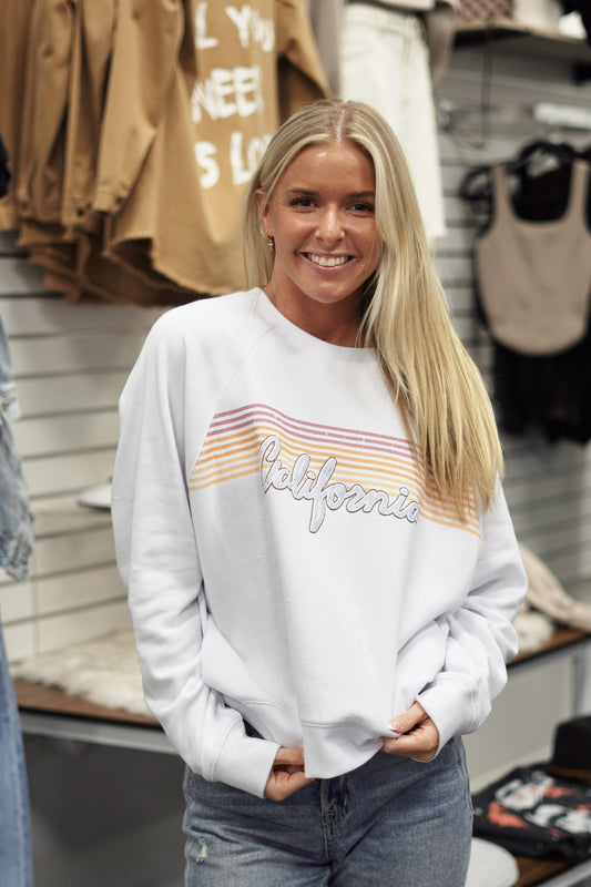 California Vintage Sweatshirt Crew Neckline Long Cuffed Sleeves Color: White "California" Scripted over a retro print Full Length Relaxed Fit 60% Cotton, 40% Polyester